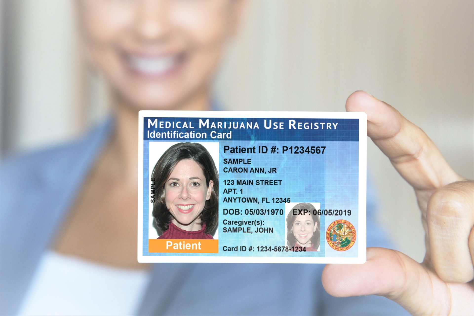 Patient holding an example Medical Marijuana Use Registry Identification Card