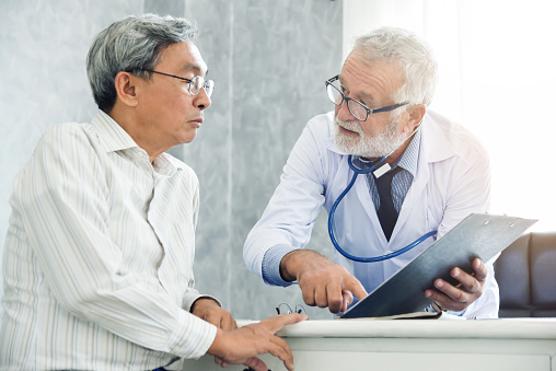 Physician explaining some paperwork to a patient.